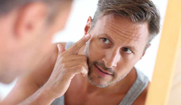 homme regardant son visage et les signes de l'age